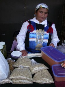 Bolivian woman selling quinoa by the pound.