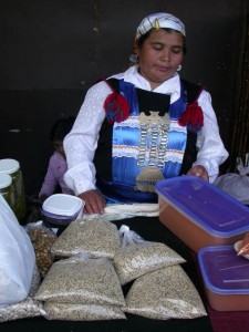 Bolivian woman selling quinoa by the pound. Bolivian woman selling quinoa by the pound.